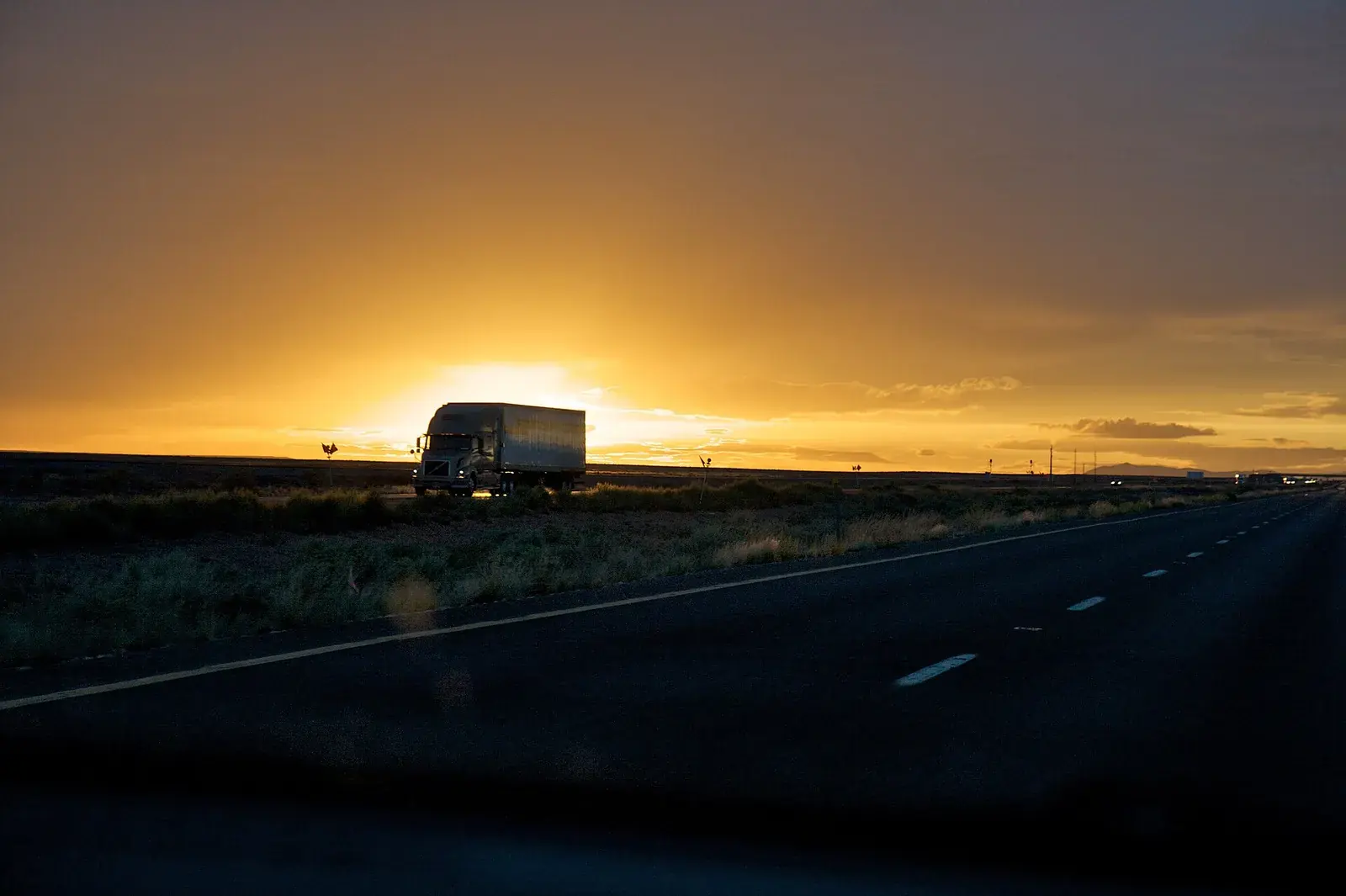 Truck on a desert highway at sunset in Arizona